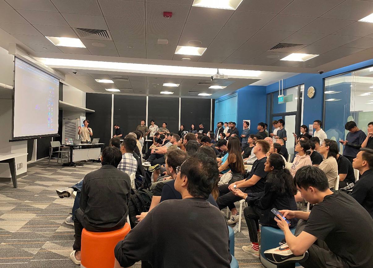 Jonathan speaking to an audience at a Menlo robotics event.